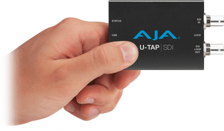Image of a hand holding an AJA Utap device.